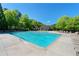 Spacious community pool with lounge chairs and picturesque landscaping for a perfect day of leisure and relaxation at 6715 Pond Rd, Cumming, GA 30040
