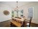 Bright dining room with wood table, bench seating, chandelier, and decorative wall art at 6715 Pond Rd, Cumming, GA 30040