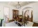 Elegant dining room with grand hutch, hardwood floors, and seamless access to kitchen at 6715 Pond Rd, Cumming, GA 30040