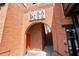 Brick entrance with archway and vintage signage, leading to a staircase and elevator, blending historic charm with modern accessibility at 6715 Pond Rd, Cumming, GA 30040