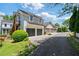 Two-story home showcasing a well-manicured lawn and a two-car garage, perfect for suburban living at 6715 Pond Rd, Cumming, GA 30040