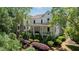 Beautiful two-story home with a covered front porch and lush landscaping at 6715 Pond Rd, Cumming, GA 30040