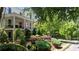 Scenic view of a home with a welcoming porch and vibrant, well-maintained landscaping at 6715 Pond Rd, Cumming, GA 30040