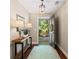 Open foyer with dark hardwood floors, console table with lamps, and an open front door to the front yard at 6715 Pond Rd, Cumming, GA 30040