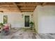 Covered front porch with slate tile, Adirondack chairs, and well-maintained landscaping at 6715 Pond Rd, Cumming, GA 30040