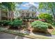 Charming two-story home with a covered front porch, landscaped yard, and a staircase leading to the front door at 6715 Pond Rd, Cumming, GA 30040