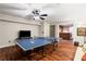 Basement recreation room with ping pong table, wood floors, television, and a bar at 6715 Pond Rd, Cumming, GA 30040