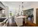 Spacious kitchen featuring wood floors, a center island, and stainless steel appliances at 6715 Pond Rd, Cumming, GA 30040