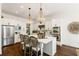 Modern kitchen featuring white cabinets, stainless steel appliances, and a large island with bar seating at 6715 Pond Rd, Cumming, GA 30040