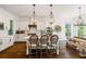 Bright, modern kitchen with white cabinets, a large island, and elegant lighting fixtures at 6715 Pond Rd, Cumming, GA 30040