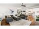 Open living room with plush seating, hardwood floors, and seamless flow to kitchen area at 6715 Pond Rd, Cumming, GA 30040