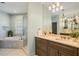 Bright bathroom featuring double vanity, large mirrors, soaking tub, walk-in shower, and ample space at 6715 Pond Rd, Cumming, GA 30040