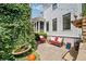 Charming outdoor patio area with stone pavers, fountain, seating, and lush landscaping at 6715 Pond Rd, Cumming, GA 30040