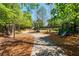 Fun community playground with slides, swings, and play structures nestled in a shaded, natural environment at 6715 Pond Rd, Cumming, GA 30040