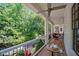 Charming porch with outdoor seating, perfect for enjoying the lush greenery and serene views at 6715 Pond Rd, Cumming, GA 30040