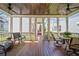 Relaxing screened-in porch with wood ceiling, ceiling fans, and ample seating area at 6715 Pond Rd, Cumming, GA 30040