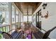 Inviting screened porch with wood ceiling, ceiling fan, and comfortable seating overlooking the yard at 6715 Pond Rd, Cumming, GA 30040