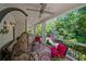 Charming covered porch with hanging chair, comfortable seating and outdoor decor offering a relaxing retreat at 6715 Pond Rd, Cumming, GA 30040