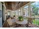 Cozy screened-in porch with comfortable seating and a decorative table at 6715 Pond Rd, Cumming, GA 30040