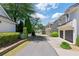 Street view of townhomes with garages, lush greenery, and well-manicured lawns, creating a welcoming atmosphere at 6715 Pond Rd, Cumming, GA 30040