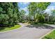 Charming neighborhood view features two-story homes with landscaped yards and tree-lined streets on a sunny day at 6715 Pond Rd, Cumming, GA 30040