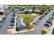 Aerial view of vibrant town center with ample parking, restaurants, and communal green space at 6715 Pond Rd, Cumming, GA 30040