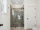 Modern shower with stylish tile, glass doors, and contrasting dark fixtures at 101 Mission Se Way # 101, Atlanta, GA 30315