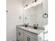 Modern bathroom featuring double granite sinks and a large well-lit mirror at 101 Mission Se Way # 101, Atlanta, GA 30315