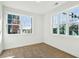 Sunlit bedroom with neutral carpet, fresh white paint, and large windows at 101 Mission Se Way # 101, Atlanta, GA 30315