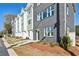 Townhome with gray brick and green siding showing multiple windows and manicured mulch beds at 101 Mission Se Way # 101, Atlanta, GA 30315