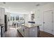 Bright kitchen with large island, granite countertops, stainless appliances, and hardwood floors at 101 Mission Se Way # 101, Atlanta, GA 30315