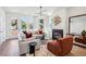 Stylish living room with modern light fixture, fireplace, and hardwood flooring at 101 Mission Se Way # 101, Atlanta, GA 30315