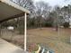 Large, fenced backyard with shed and mature trees, offering a private outdoor retreat at 2195 Wilson Rd, Conyers, GA 30012
