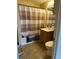 Full bathroom with a striped shower curtain, a vanity, and a standard toilet at 2195 Wilson Rd, Conyers, GA 30012