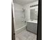 Bathroom with a shower-tub combo, a gray vanity with sink, and neutral flooring at 2195 Wilson Rd, Conyers, GA 30012