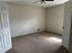 This bedroom features neutral carpet, a ceiling fan with lights, and white trim and doors at 2195 Wilson Rd, Conyers, GA 30012