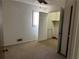 Neutral carpeted bedroom with ceiling fan, closet, window and view into the closet at 2195 Wilson Rd, Conyers, GA 30012