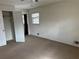 Bedroom view featuring neutral carpet, closet, window, and white trim and doors at 2195 Wilson Rd, Conyers, GA 30012