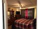 Bedroom with red and black plaid bedspread and brown drapes at 2195 Wilson Rd, Conyers, GA 30012