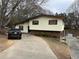 Split level home showcasing a long driveway leading up to the two-story house with brick and siding at 2195 Wilson Rd, Conyers, GA 30012