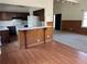 Eat-in kitchen with wood cabinets, white appliances, and a view into the living room at 2195 Wilson Rd, Conyers, GA 30012
