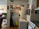 Laundry area with washer and dryer, shelving, and a view into the living room at 2195 Wilson Rd, Conyers, GA 30012