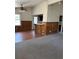 Open living area with wood-paneled walls, neutral carpet and views into the kitchen area at 2195 Wilson Rd, Conyers, GA 30012