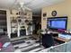 Open living area features a flat screen TV, shelving, and view of the kitchen at 2195 Wilson Rd, Conyers, GA 30012