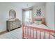 Brightly lit bedroom with a wooden bed and patterned rug at 235 Ivey Ter, Temple, GA 30179