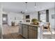 Open-concept kitchen with island flows into the dining and living areas at 235 Ivey Ter, Temple, GA 30179