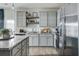 Modern kitchen featuring granite countertops, stainless steel appliances, and sleek gray cabinetry at 235 Ivey Ter, Temple, GA 30179