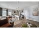 Open concept living space with an eat in kitchen and stainless steel appliances under recessed lighting at 235 Ivey Ter, Temple, GA 30179