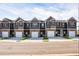 New construction townhomes featuring individual garages and modern exterior finishes in a desirable community at 235 Ivey Ter, Temple, GA 30179