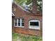 Home exterior highlighting brick facade, windows, and a satellite dish, blending functionality with classic design at 240 Mathewson Sw, Atlanta, GA 30314